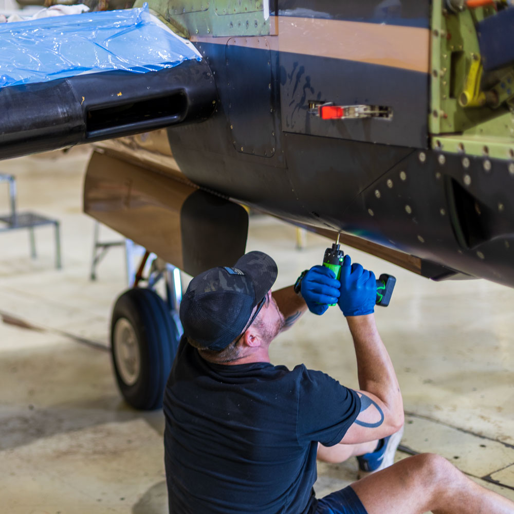DV Aviation technician inspecting aircraft engine